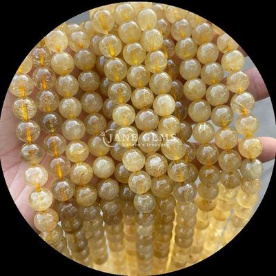 Piedra polida de corte redondo de fuego cuarzo dorado Rutilated cuartzo hilos de perlas para la fabricación de joyas DIY