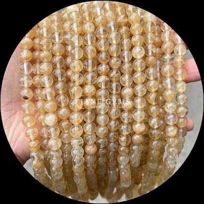 Piedra polida de corte redondo de fuego cuarzo dorado Rutilated cuartzo hilos de perlas para la fabricación de joyas DIY
